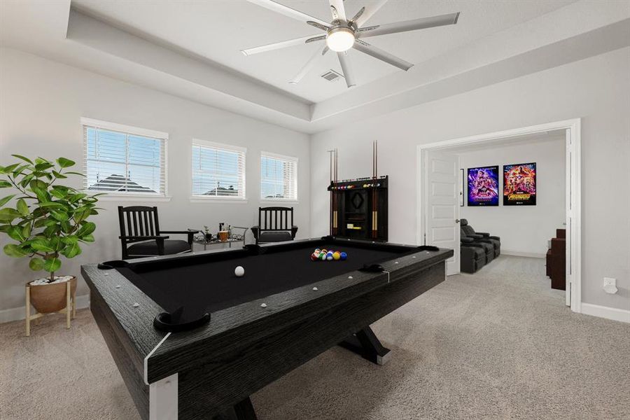 Come upstairs and enjoy a day of leisure in this fabulous game room/media room! This is the perfect hangout spot or adult game room, this space features plush carpet, high vaulted ceiling, custom modern fan, neutral paint and plenty of natural light.