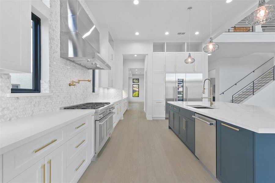 Appliances include, Thermador 48" gas range with two ovens, Thermador dishwasher and built-in refrigerator, freezer and wine storage. The floor to ceiling storage continues into the butler's pantry and scullery kitchen/pantry.