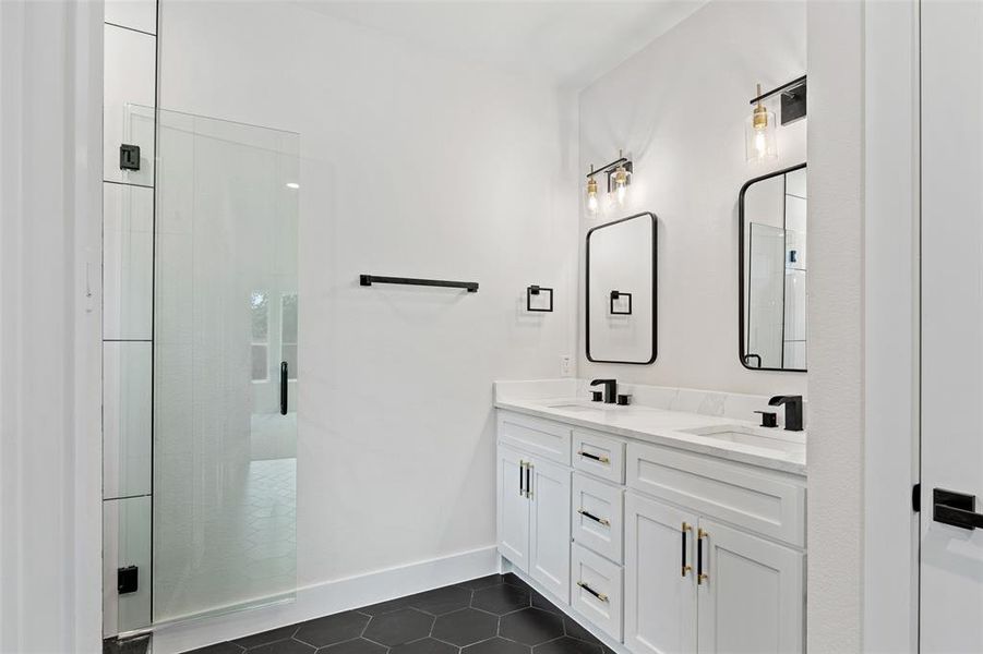 Bathroom with vanity, an enclosed shower, and tile patterned floors