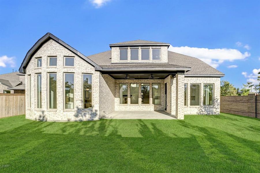 View of the back of the home featuring many beautiful windows!