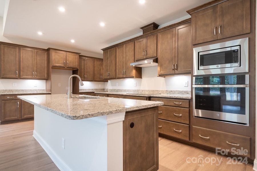 The Sellers spared no expense in this breathtaking Gourmet Kitchen w/soft close upgraded cabinetry, granite counters, Kohler Neoroc sink and upgraded GE stainless steel appliances.