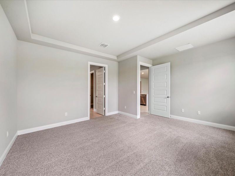 Primary Bedroom in the Coral floorplan at 6326 NW Sweetwood Drive in Brystol at Wylder