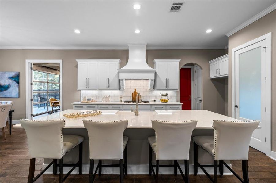 This stunning kitchen features a large kitchen island with plenty of seating for casual meals!