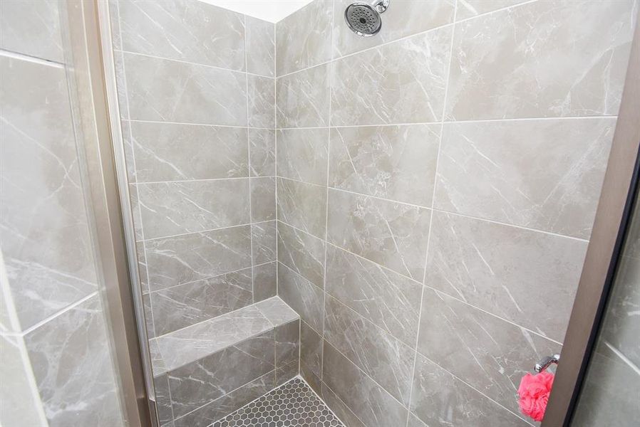 Step down shower with sitting area