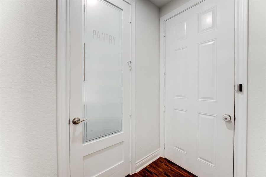 A frosted glass door invites you in to the walk-in pantry.