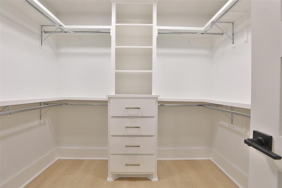 Primary closet with shoe rack and built-in drawers