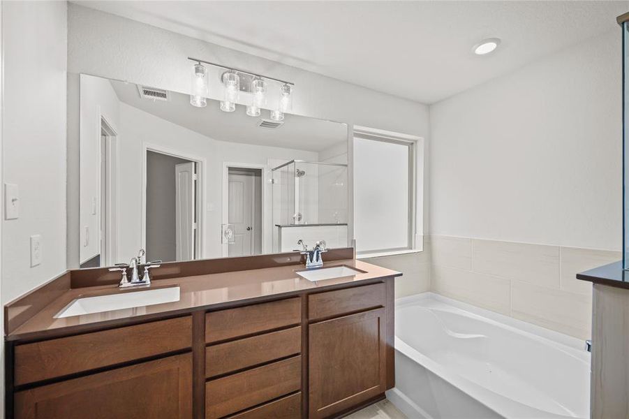 Welcome to the beautifully appointed primary bath with double sinks, a serene oasis designed for comfort and style.