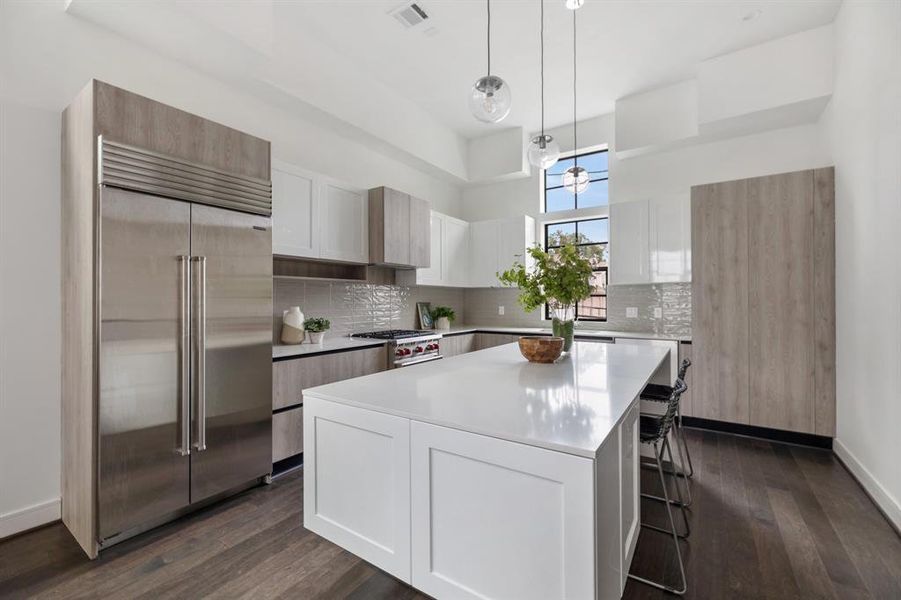 Equipped with Wolf Gourmet Premium Appliances, including a 30” range with cooktop and oven, Wolf Microwave Drawer, and a 24” Bosch Dishwasher, this kitchen is designed for culinary excellence.