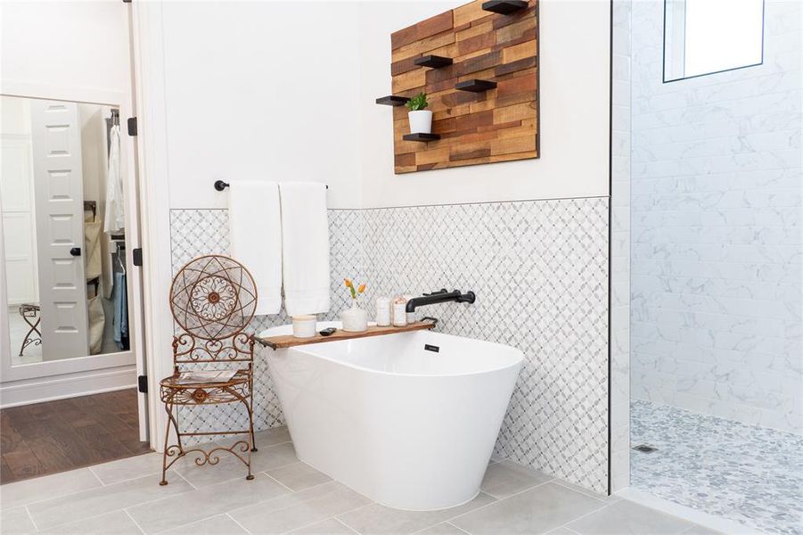 Bathroom featuring independent shower and bath, tile walls, and tile patterned flooring