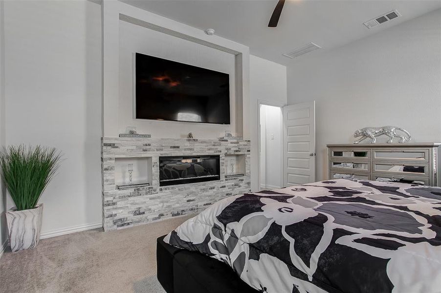 Primary bedroom with custom fireplace