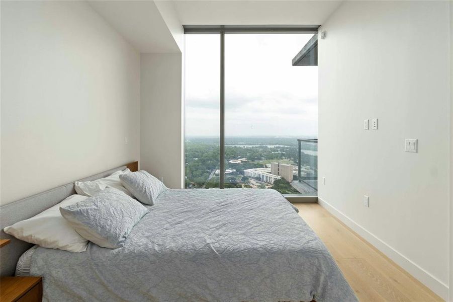 Bedroom with floor to ceiling windows with views of downtown Austin and Lady Bird Lake