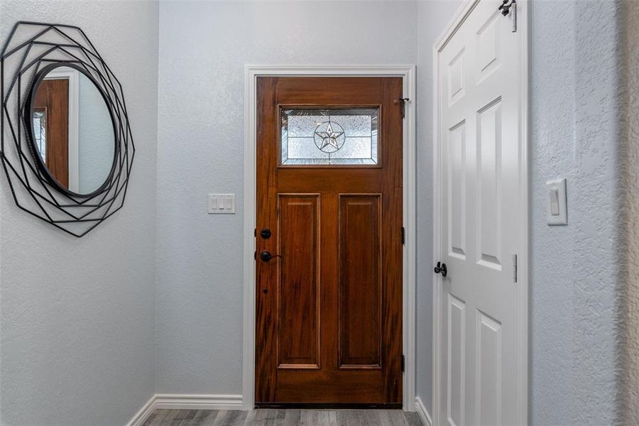 A welcoming front entry hall with storage closet.