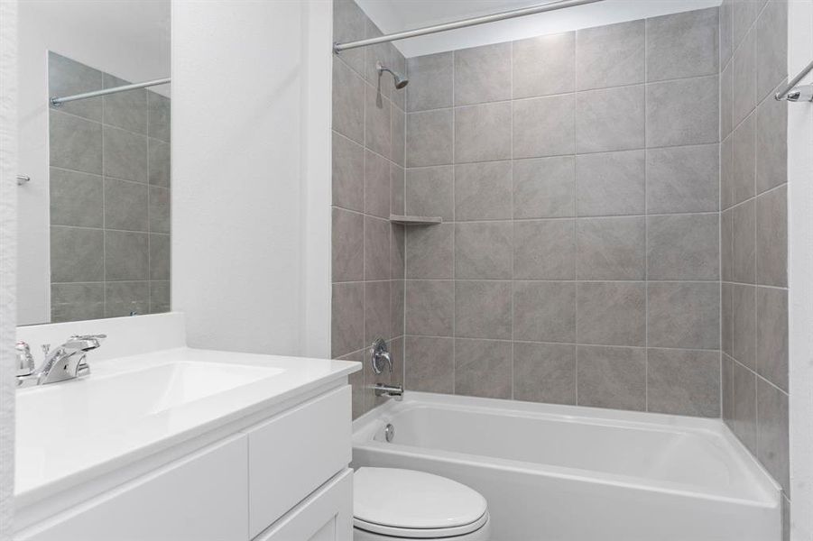 The Guest Bathroom has Large Beautiful Vinyl Plank Like Wood Floors, and Large Vanity!  All of our Bathrooms have Upgraded Elongated Commodes! Tub and Shower Combination with gorgeous Tile Surroundings and more. **Representative Photo of Plan only and may vary as built**