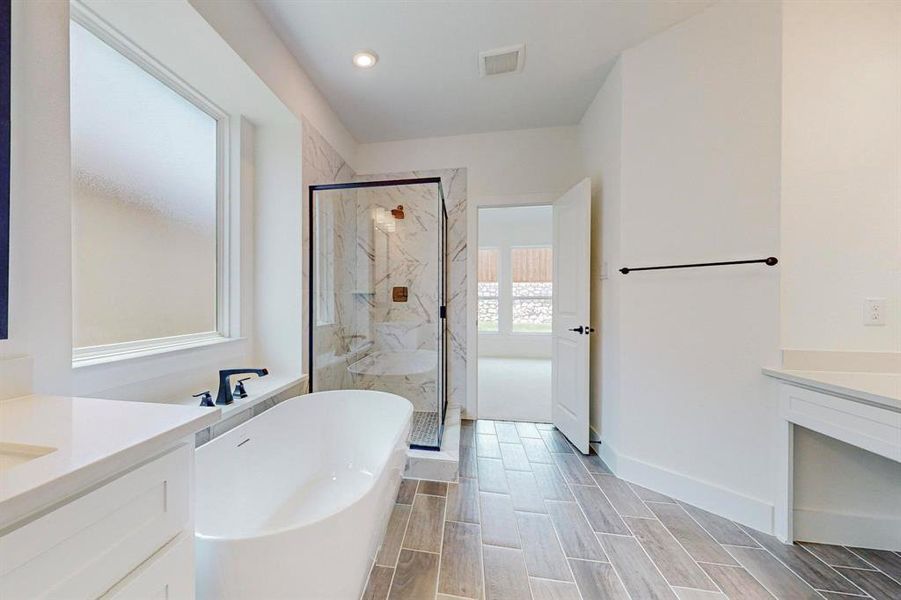 Bathroom with vanity and independent shower and bath