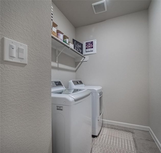 large laundry room with storage and tile flooring