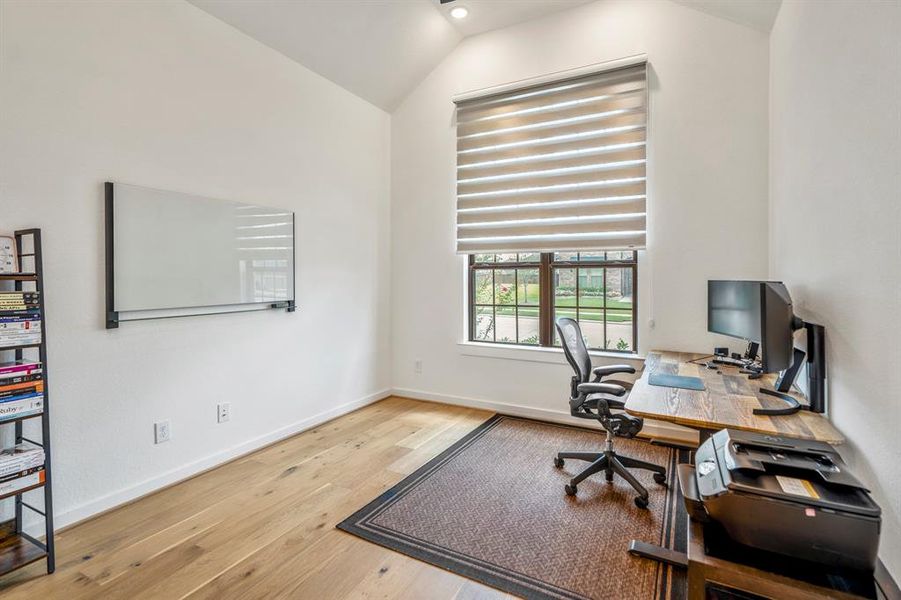 Nestled away quietly in the front of the home is the grand home office! Featuring high ceilings, recessed lighting, wood flooring, and bright natural light, this is the ideal space to work from home!