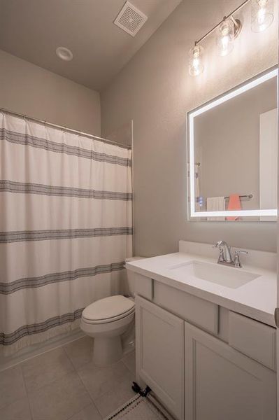 Secondary bath with tub/shower combo features Quartz countertops, under mount sink and a 3 color tone LED mirror with defroster to eliminate wiping the mirror off!