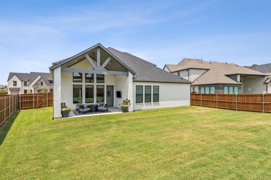 Rear view of property with a patio, and outdoor living space, and a yard