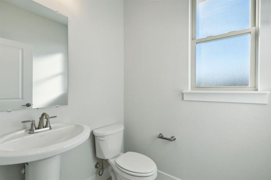 Bathroom featuring sink and toilet