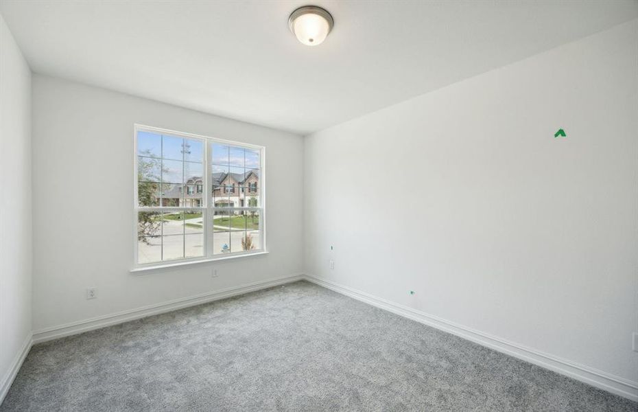 Secondary bedroom with large windows  *real home pictured