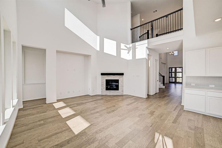 Secondary view of the main living space from the back of the home, stunning floors stretch through to the front of the home.