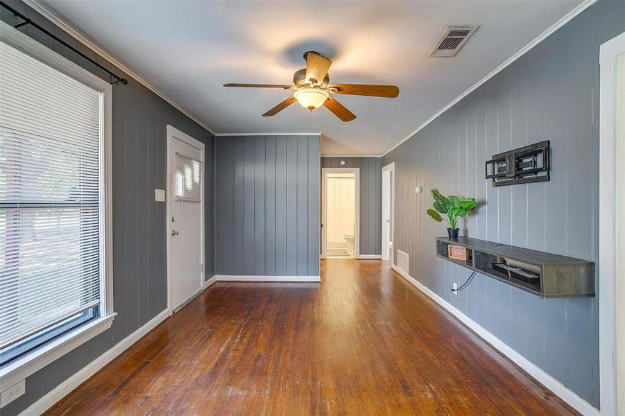 Foyer featuring ornamental molding, a wealth of natural light, and dark hardwood / wood-style flooring