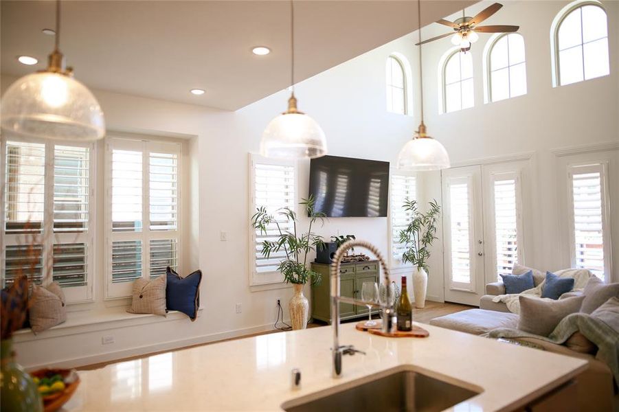 Kitchen with ceiling fan, sink, a healthy amount of sunlight, and hanging light fixtures