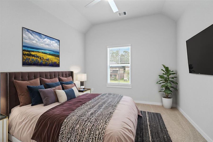 Secondary bedroom features plush carpet, custom paint, ceiling fan with lighting and a large window with privacy blinds.