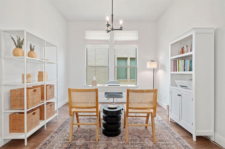 Dining area with a notable chandelier and wood-type flooring