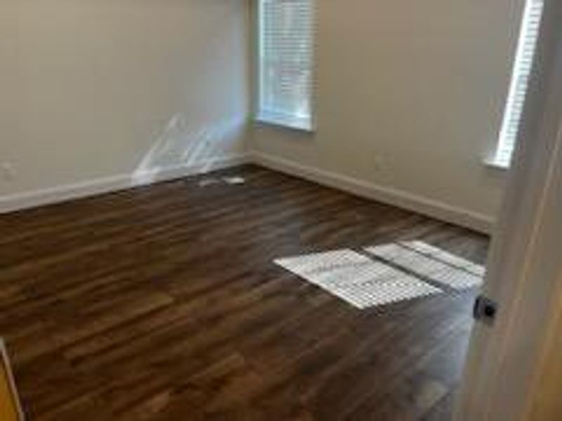 Empty room with dark wood-type flooring