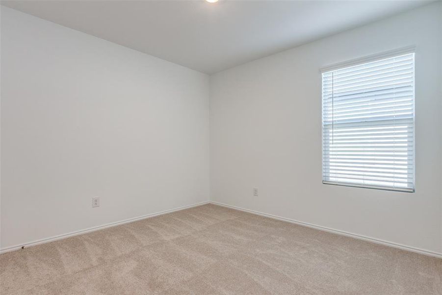 Carpeted empty room featuring plenty of natural light