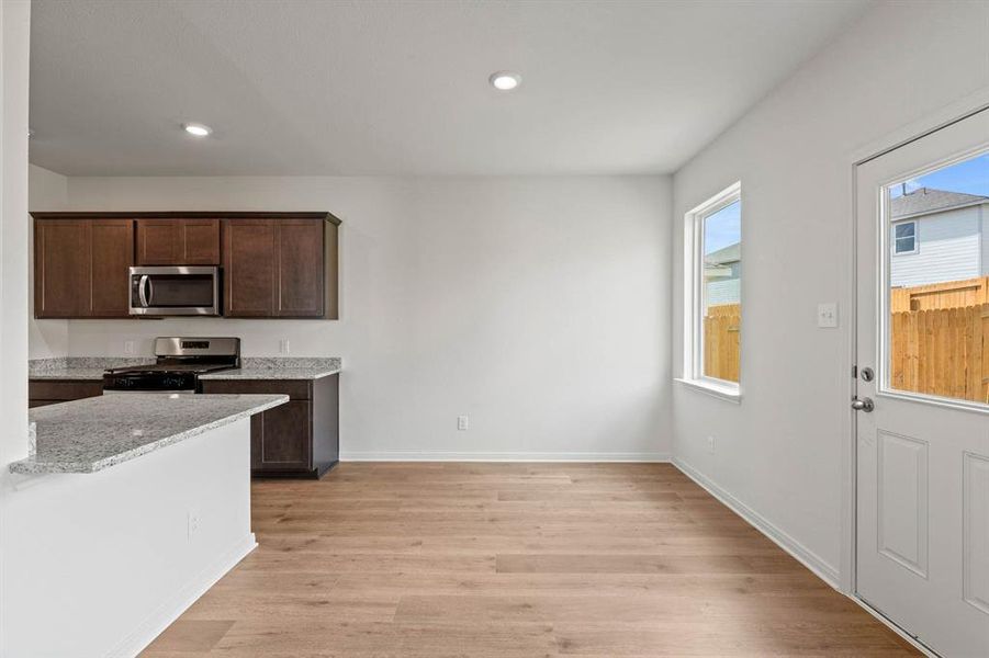 Dining area with light wood-style flooring