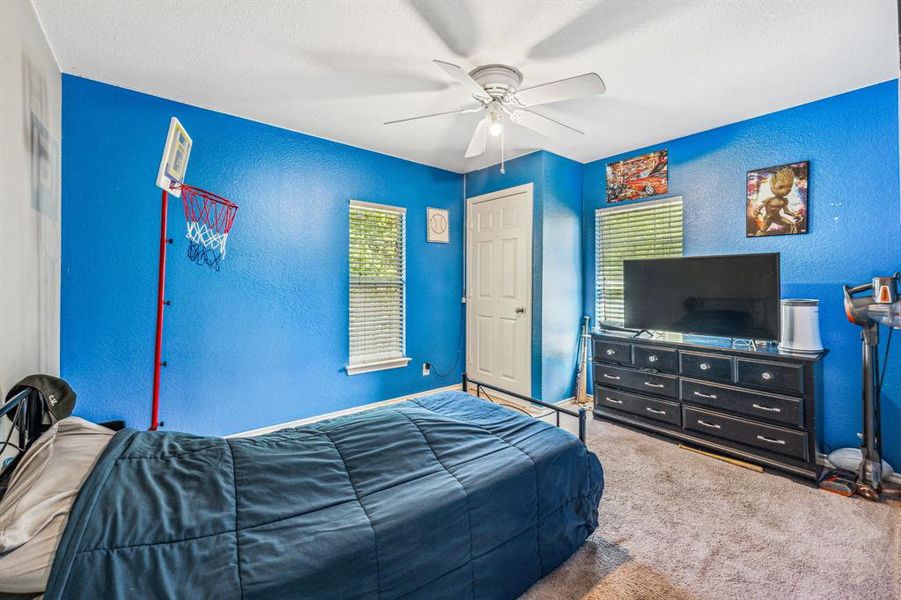 Carpeted bedroom with ceiling fan