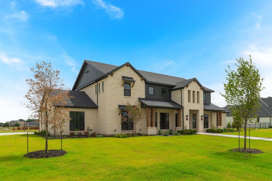 View of front of home featuring a garage and a front lawn