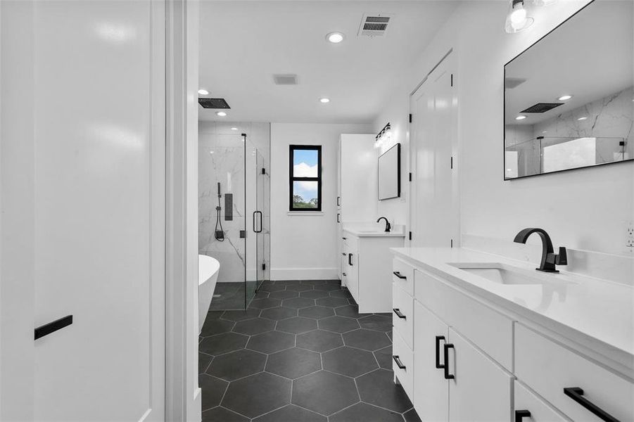 Bathroom featuring plus walk in shower, tile patterned floors, and dual bowl vanity