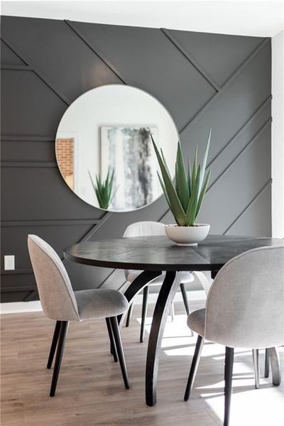 Dining space with hardwood / wood-style flooring and wall design option.