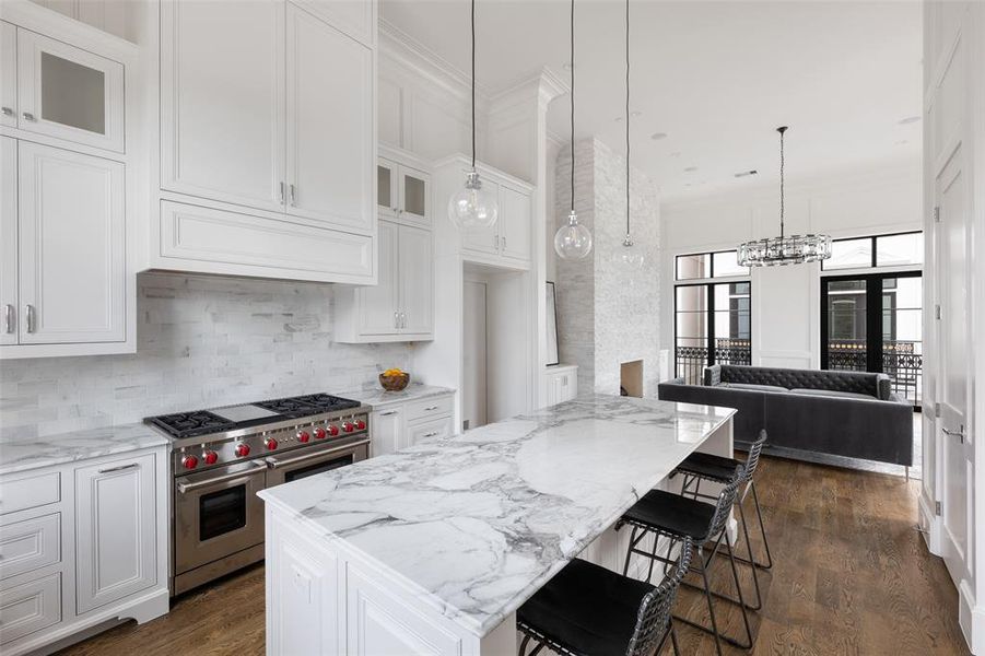 No detail is overlooked in the kitchen design, from the floor-to-ceiling double stacked cabinetry to the 10' island, every facet construction is well-planned and deliberate, a result of decades of stellar construction. Image from previously completed home in the community.