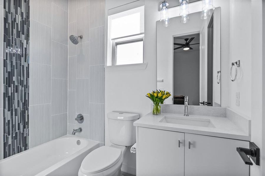 Full bathroom featuring tiled shower / bath combo, vanity