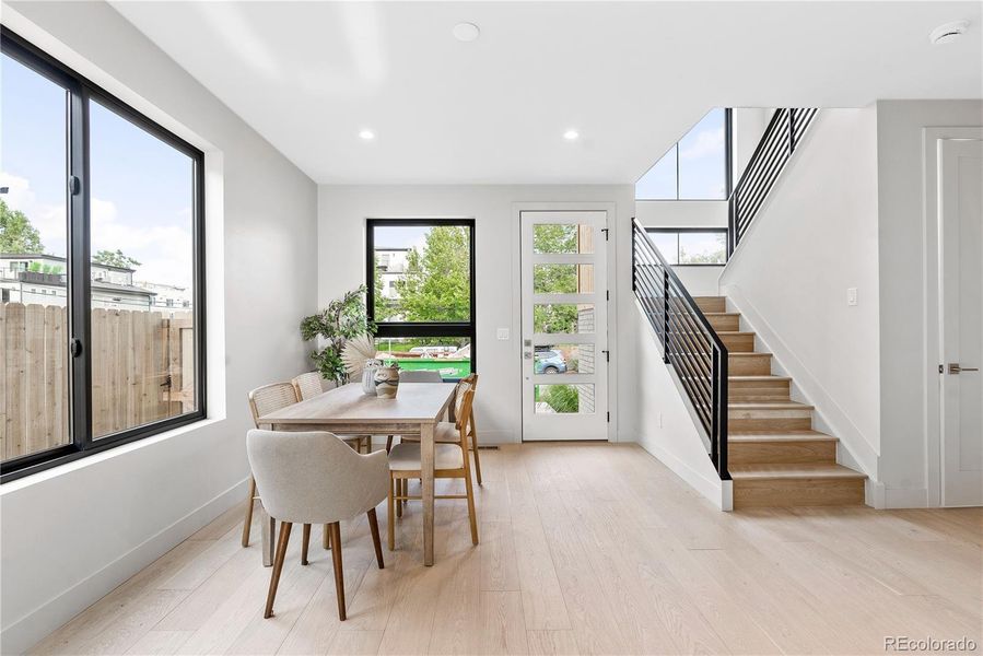 Upon entry you're greeted with a bright sun-filled dining area and generous storage space and coat closet to the right of the staircase.