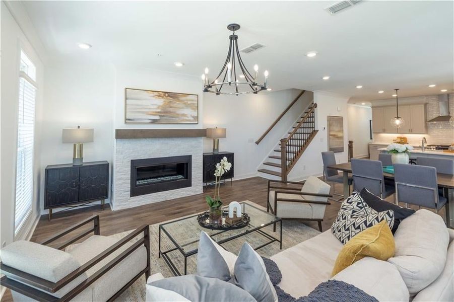 Living room with light wood-type flooring, sink, a wealth of natural light,Open Spec Concept perfect for family gatherings . Not the actual unit