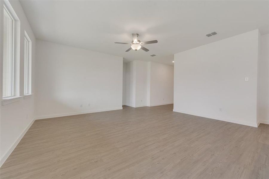 Spare room with ceiling fan and light hardwood / wood-style floors