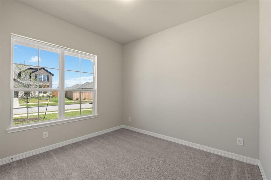 Your secondary bedroom features plush carpet, fresh paint, closet, and a large window that lets in plenty of natural lighting.