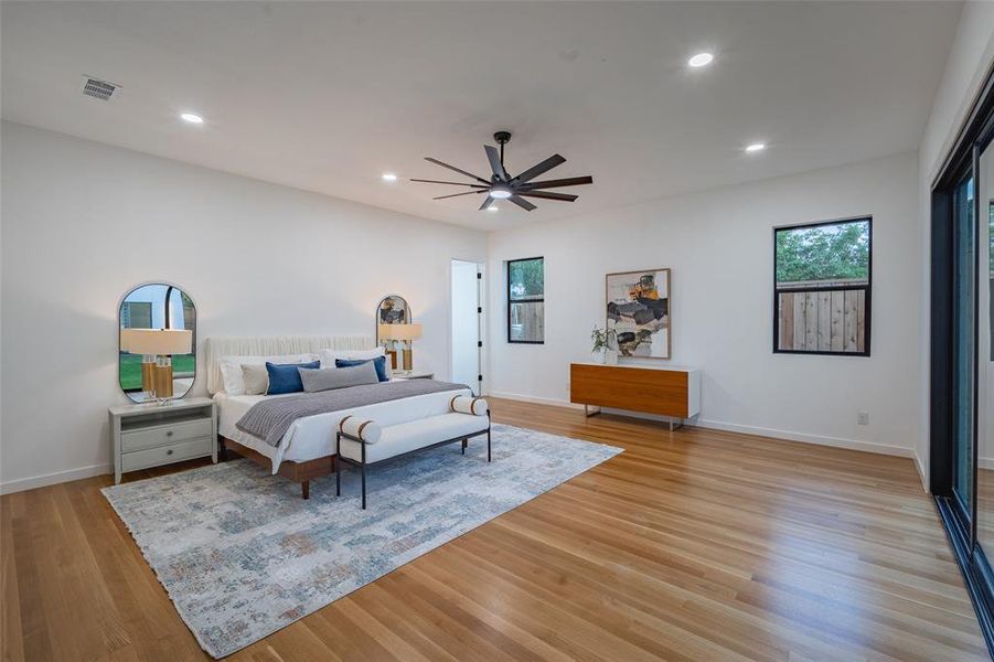 Bedroom with light hardwood / wood-style floors and ceiling fan