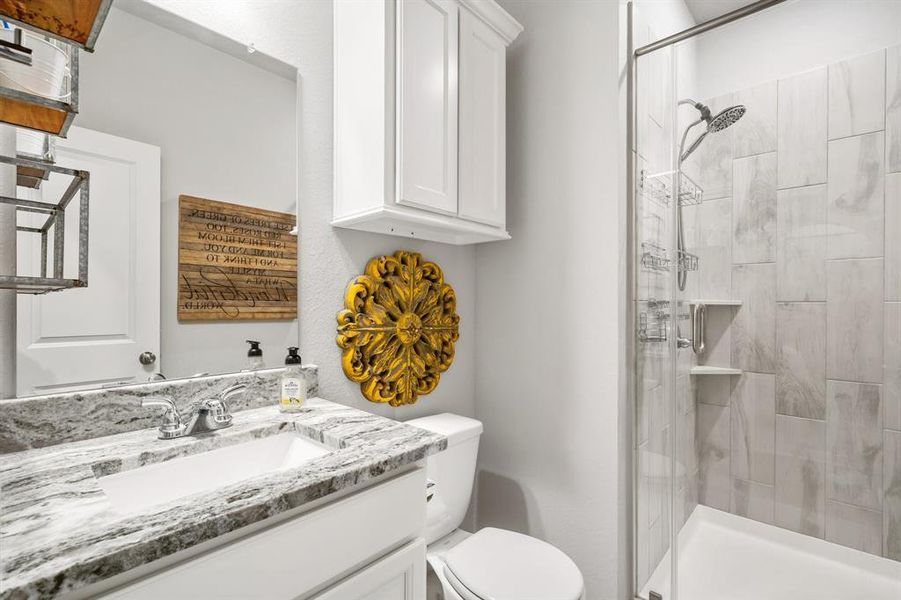 Full bath and shower downstairs conveniently located by the fourth or guest bedroom!  Granite countertops and tile surround shower!