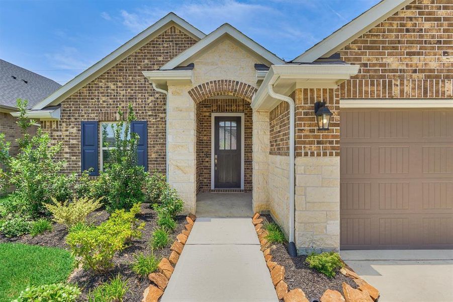 This lovely Beazer home offers an attractive brick and limestone elevation
