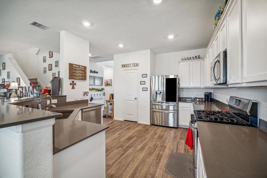 Spacious and functional, the large kitchen is designed with both style and convenience in mind. Featuring ample counter space, modern appliances, and a breakfast bar, it’s perfect for casual dining or entertaining. The open layout flows effortlessly into the dining and living areas, making this kitchen the heart of the home.