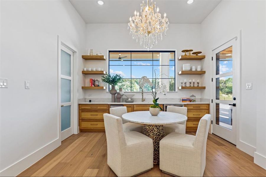 Airy space with wet bar featuring wine cooler, ice machine