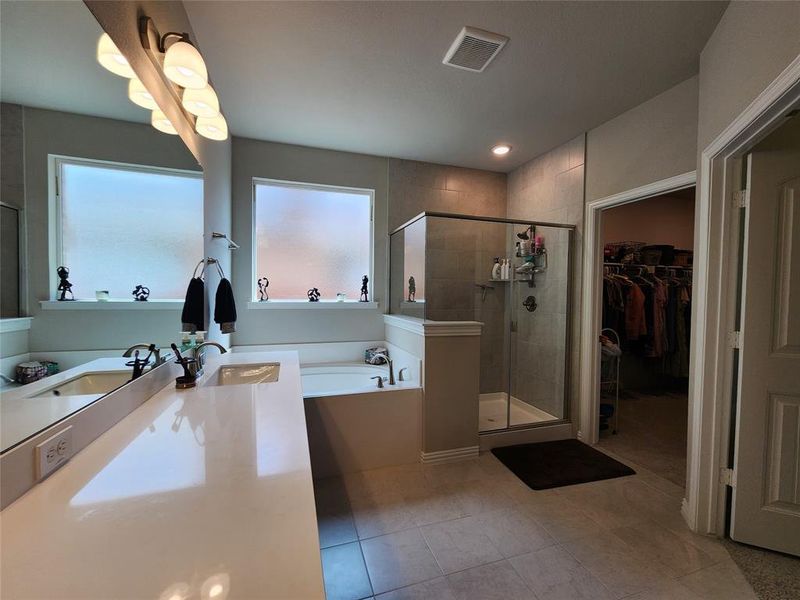 Bathroom with tile patterned floors, sink, and independent shower and bath