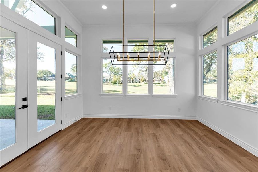 Enjoy views of the golf course green from 3 sides of the light filled dining room.