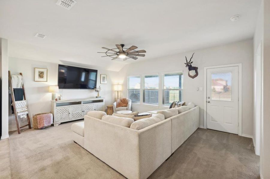 Living room with carpet floors and ceiling fan